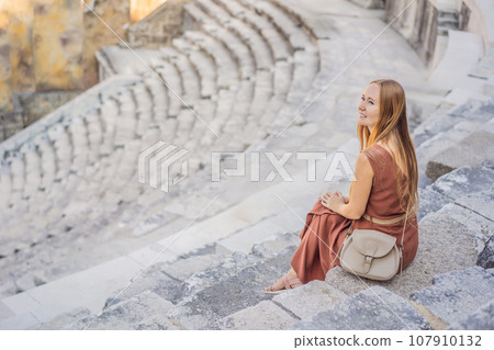 Woman tourist explores Aspendos Ancient City. Aspendos acropolis city ruins, cisterns, aqueducts and old temple. Aspendos Antalya Turkey. turkiye Woman tourist explores Aspendos Ancient City. Aspendos acropolis city ruins, cisterns, aqueducts and old temple. Aspendos Antalya Turkey. turkiye 107910132