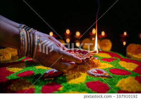 Clay diya lamps lit during diwali celebration, Diwali, or Deepavali, is India's biggest and most important holiday. Clay diya lamps lit during diwali celebration, Diwali, or Deepavali, is India's biggest and most important holiday. 107910192