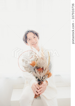 man with dried flowers man with dried flowers 107910736
