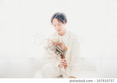 man with dried flowers man with dried flowers 107910737