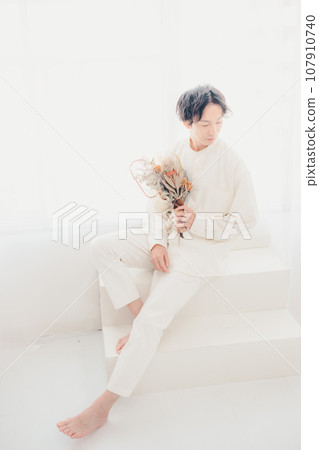 man with dried flowers man with dried flowers 107910740