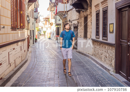 Happy man tourist on background of old street of Antalya. male tourist traveler discover interesting places and popular attractions and walks in the old city Kalechi of Antalya, Turkey. Turkiye Happy man tourist on background of old street of Antalya. male tourist traveler discover interesting places and popular attractions and walks in the old city Kalechi of Antalya, Turkey. Turkiye 107910786