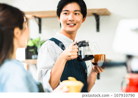 Young men and women working in a cafe Young men and women working in a cafe 107910790
