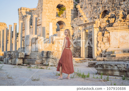 Pretty tourist woman at the ruins of ancient city of Perge near Antalya Turkey Pretty tourist woman at the ruins of ancient city of Perge near Antalya Turkey 107910886