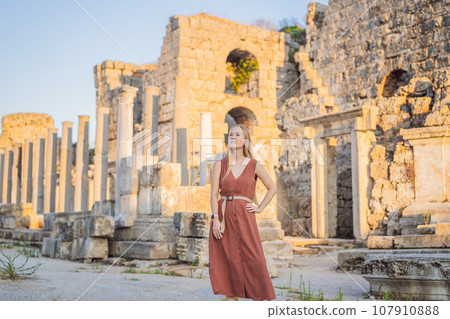 Pretty tourist woman at the ruins of ancient city of Perge near Antalya Turkey Pretty tourist woman at the ruins of ancient city of Perge near Antalya Turkey 107910888