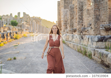 Pretty tourist woman at the ruins of ancient city of Perge near Antalya Turkey Pretty tourist woman at the ruins of ancient city of Perge near Antalya Turkey 107910904