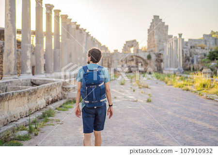 Tourist man at the ruins of ancient city of Perge near Antalya Turkey Tourist man at the ruins of ancient city of Perge near Antalya Turkey 107910932