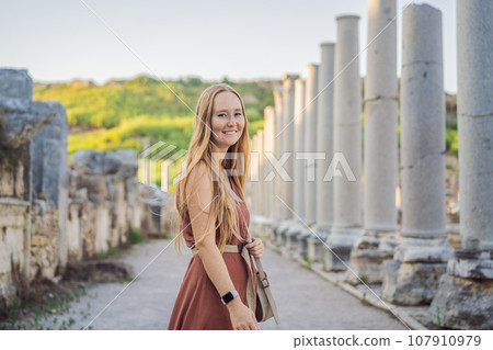 Pretty tourist woman at the ruins of ancient city of Perge near Antalya Turkey Pretty tourist woman at the ruins of ancient city of Perge near Antalya Turkey 107910979