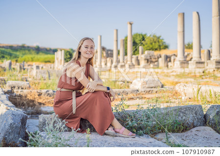 Pretty tourist woman at the ruins of ancient city of Perge near Antalya Turkey Pretty tourist woman at the ruins of ancient city of Perge near Antalya Turkey 107910987