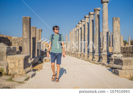 Tourist man at the ruins of ancient city of Perge near Antalya Turkey Tourist man at the ruins of ancient city of Perge near Antalya Turkey 107910993