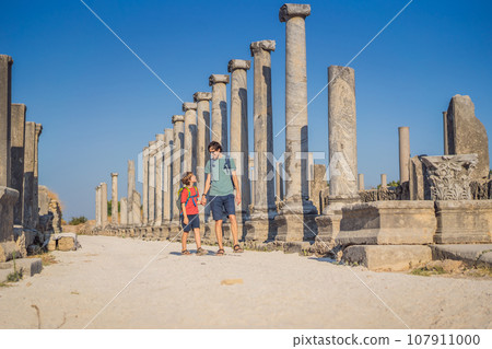 dad and son tourists at the ruins of ancient city of Perge near Antalya Turkey. Traveling with kids concept dad and son tourists at the ruins of ancient city of Perge near Antalya Turkey. Traveling with kids concept 107911000