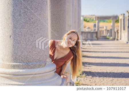 Pretty tourist woman at the ruins of ancient city of Perge near Antalya Turkey 107911017