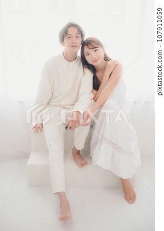 Couple relaxing in white clothes Couple relaxing in white clothes 107911059