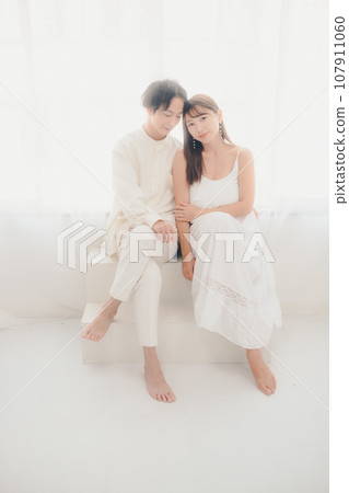 Couple relaxing in white clothes Couple relaxing in white clothes 107911060
