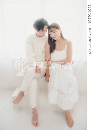 Couple relaxing in white clothes Couple relaxing in white clothes 107911061