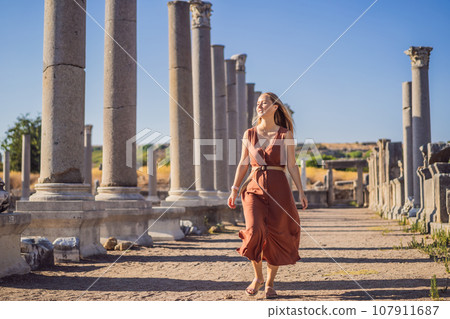 Pretty tourist woman at the ruins of ancient city of Perge near Antalya Turkey Pretty tourist woman at the ruins of ancient city of Perge near Antalya Turkey 107911687