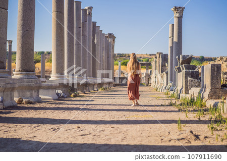 Pretty tourist woman at the ruins of ancient city of Perge near Antalya Turkey Pretty tourist woman at the ruins of ancient city of Perge near Antalya Turkey 107911690
