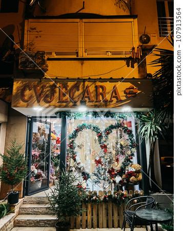 Flower shop window with Christmas decorations Flower shop window with Christmas decorations 107913564