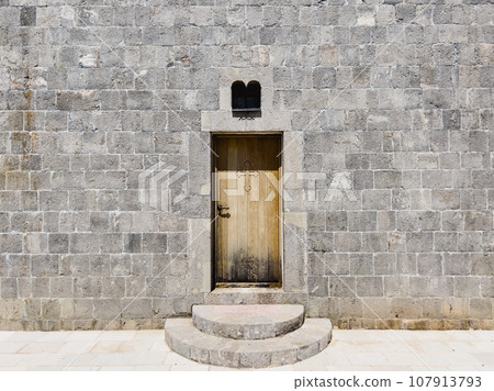 Wooden door with a cross of the Church of the Holy Trinity. Budva, Montenegro Wooden door with a cross of the Church of the Holy Trinity. Budva, Montenegro 107913793