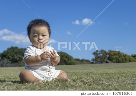 Baby sitting in a grassy park (boy, 0 years old, 10 months old, Japanese) Baby sitting in a grassy park (boy, 0 years old, 10 months old, Japanese) 107916365