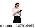 A woman in a suit operates a cell phone seriously. 107916965