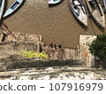 A person bathes in the Ganges River in Varanasi, India. 107916979