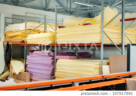 Stacked sheets of foam rubber for furniture production in factory workshop 107917892
