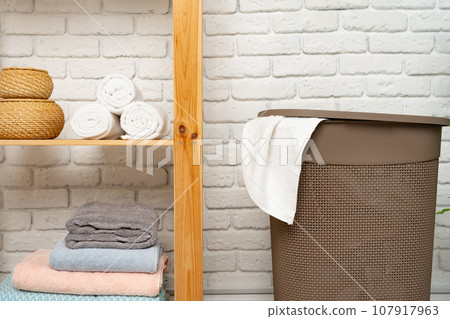 Pile of clothes in plastic laundry basket in the bathroom Pile of clothes in plastic laundry basket in the bathroom 107917963