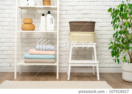 Plastic storage baskets in a bathroom interior Plastic storage baskets in a bathroom interior 107918027