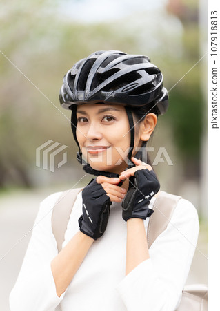young woman wearing a cycling helmet young woman wearing a cycling helmet 107918813
