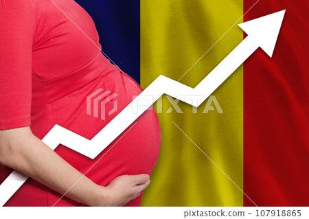 Pregnant woman close up on flag of Romania background. Birth rate up 107918865