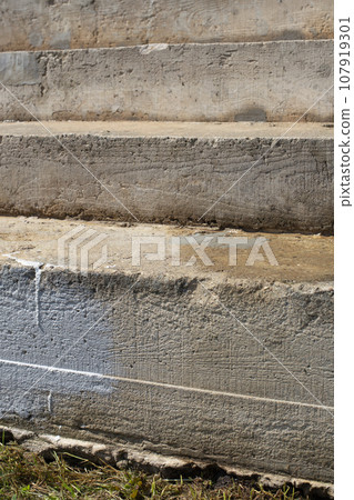 Concrete steps on the street. The porch steps are made of concrete with different patterns. 107919301