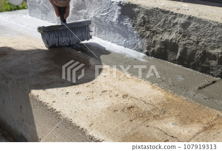 Covering the steps with a special protective solution. Brush with paint. Covering the steps with a special protective solution. Brush with paint. 107919313