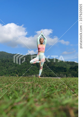 vibrant portrait of a girl doing morning workout and stretching 107920005