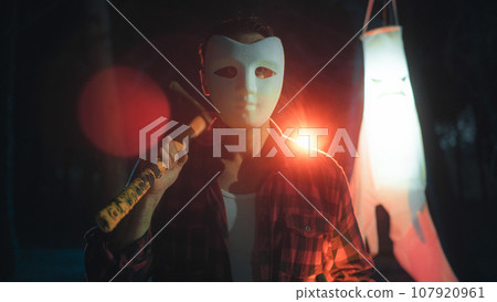 Masked man as concept of fear and terror on Halloween 107920961
