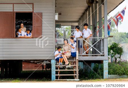 Woman teacher teach and train her student in area of steps of the building with some student Woman teacher teach and train her student in area of steps of the building with some student 107920984