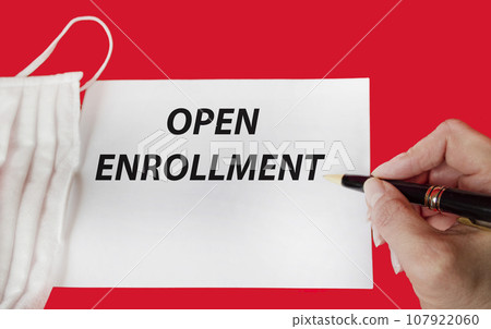 Open registration. Text and woman's hand holding pen on notepad Open registration. Text and woman's hand holding pen on notepad 107922060