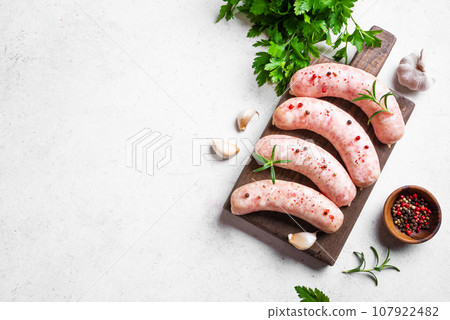Raw sausages with spices and rosemary 107922482