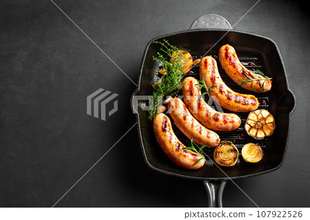 Grilled sausages on cast iron grill pan 107922526