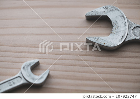 Monkey wrench placed on a wooden board Monkey wrench placed on a wooden board 107922747