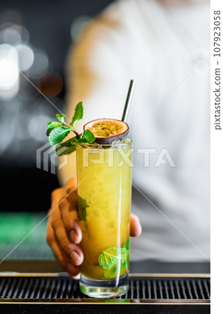 Talented Barista Creating Spectacular Cocktails at the Bar Counter 107923058