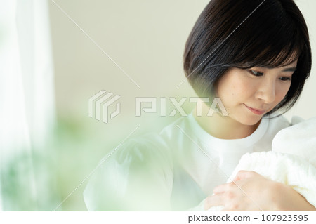 young woman holding a baby young woman holding a baby 107923595
