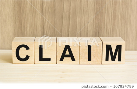 claim word written on wood block. claims text on wooden table for your desing, concept. 107924799