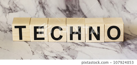 TECHNO text on wooden cubes on a marble table 107924853