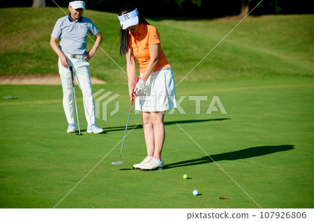 A woman puttingter A woman puttingter 107926806