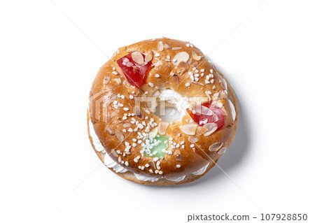 Individual Epiphany cake roscon de reyes with cream stuffed isolated on white background. Top view. Copy space Individual Epiphany cake roscon de reyes with cream stuffed isolated on white background. Top view. Copy space 107928850