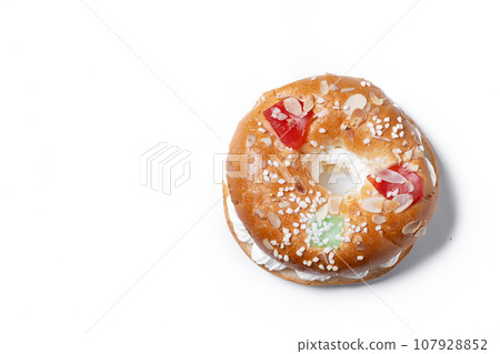 Individual Epiphany cake roscon de reyes with cream stuffed isolated on white background. Top view. Copy space 107928852