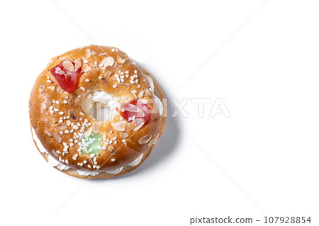 Individual Epiphany cake roscon de reyes with cream stuffed isolated on white background. Top view. Copy space Individual Epiphany cake roscon de reyes with cream stuffed isolated on white background. Top view. Copy space 107928854