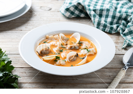 Seafood soup on wooden table Seafood soup on wooden table 107928867