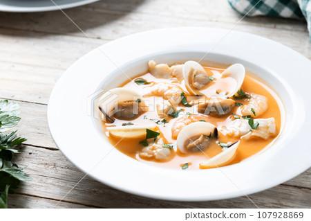 Seafood soup on wooden table Seafood soup on wooden table 107928869